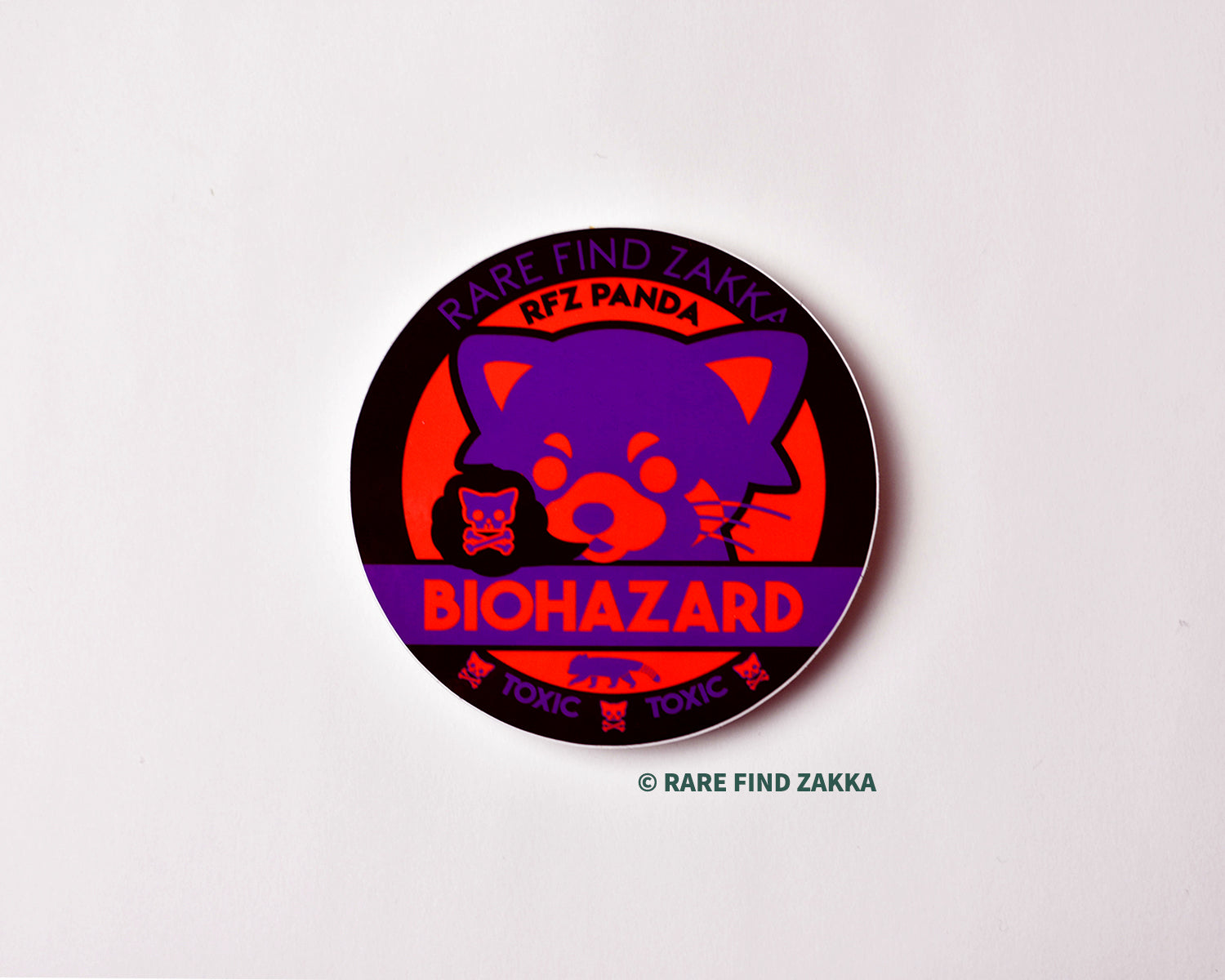 Purple red red panda round black sticker that says biohazard and toxic bones