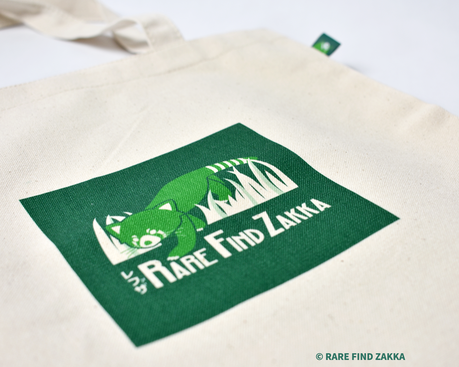 tote bag with square green red panda logo